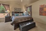 The master bedroom has a king size bed and flat screen TV